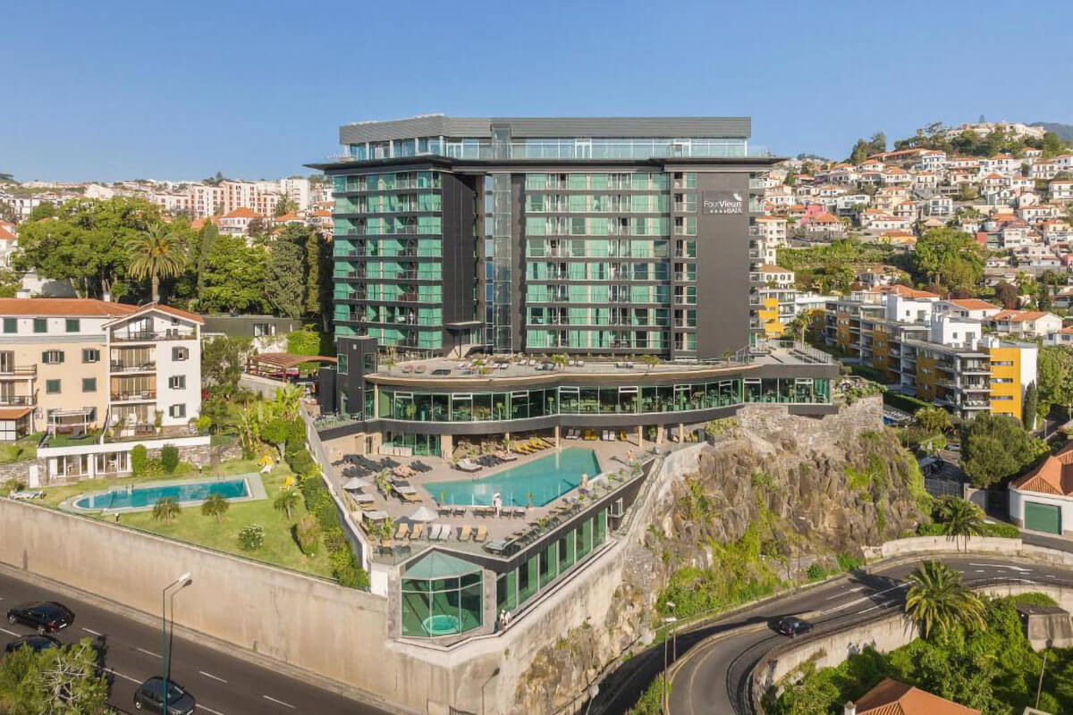 Facade and outdoor area with swimming pool at The Views Baia Funchal Hotel.